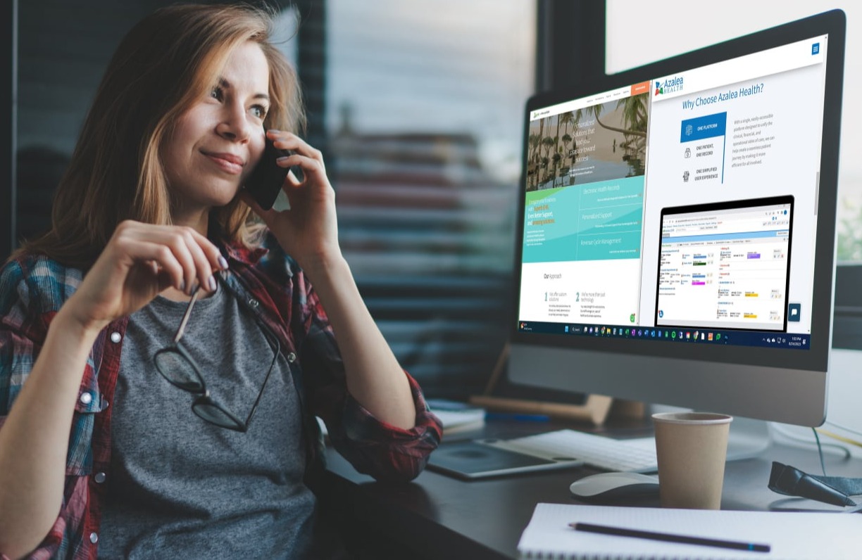 An image of a woman providing support to a customer from her work desk. The monitor is a split screen view of Azalea Health and Oasis home pages.